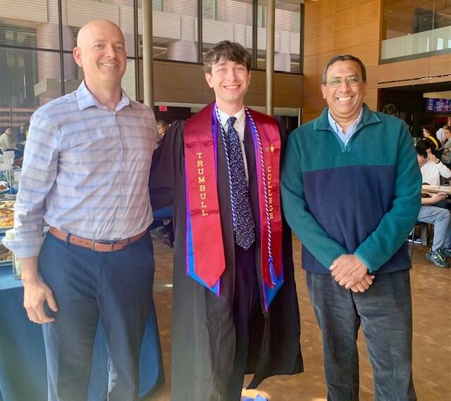 Faculty members with a recent graduate